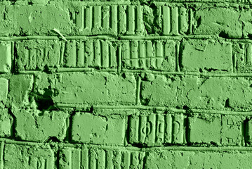 Painted brick wall close up. Abstract background green color toned