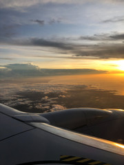 Fototapeta na wymiar Beautiful View of a sunset in a plane window 