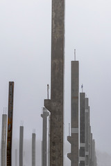 very heavy fog. concrete supports. frame of the future home. monolith