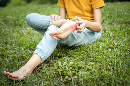 Asian Child Girl Scratch On Her Foot With Hand,foot Itch Allergy,rash In The Grass At Park,teenage Doesn’t Wear Shoes Or Walk Barefoot Will Get Parasitic In To The Skin Cause Feet Itching,Anaphylaxis