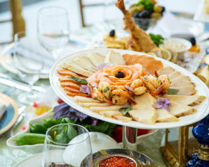 seafood platter with fried shrimps, smoked salmon and other fish slices