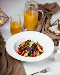 ham salad with vegetables, served with orange juice