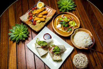 lunch set with crispy chicken, vegetables in sauce, rice and fried ham wraps