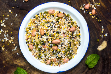 The white container holds the raw material of the eight treasures grain porridge on the board