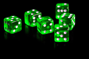 Green transparent dice on black background close-up. Gambling сoncept