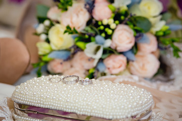 wedding rings, shoes, earrings and a bouquet of roses