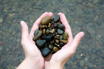 Man holds stones in his hands.