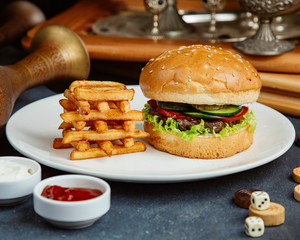 beef burger served with french fries, mayonnaise and ketchup