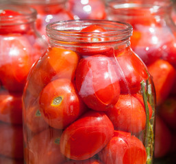 Pickling (canning) the tomatoes.