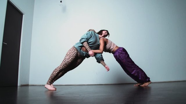Modern Dance with Two Women Leaning Against Each Other