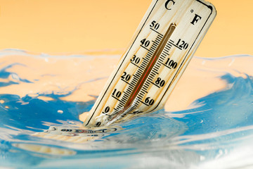 Climate change concept, thermometer immersed in water