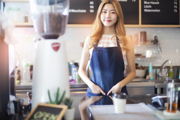 Portrait young Asian woman barista feeling happy smiling at urban cafe. Small business owner Korean girl in apron relax toothy smile