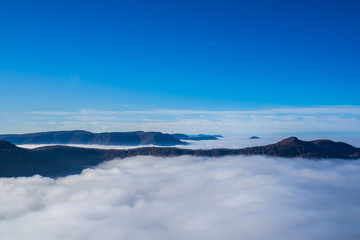 Germany, Wonderful aerial view above endless sea of clouds in valley of swabian jura nature landscape on sunny day with blue sky near stuttgart
