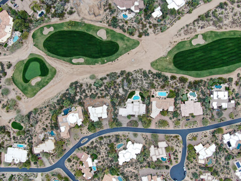 Aerial view above golf course and upscale luxury homes in Scottsdale, Arizona