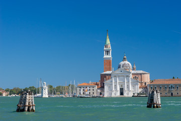 Fototapeta na wymiar View on a church at Venice through a channel