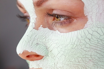 Girl with mud mask on face