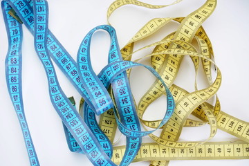 two measuring tapes on a light background