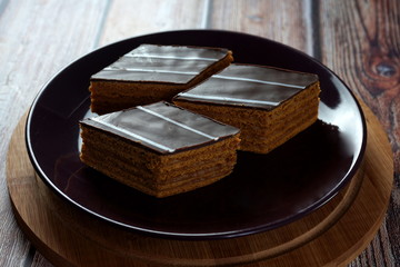 Chocolate cake on a wooden background. Chocolate cake on a wooden background. Homemade cakes, dessert