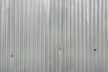 Metal zinc aluminium roofing sheet. Silver corrugated metal sheet texture background. Steel metal zinc galvanized wave metal sheet for roof and walls.