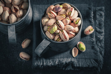 Group of pistachios in a rustic metal box
