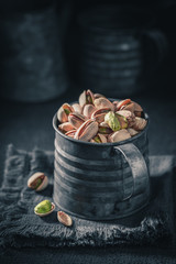 Helathy pistachios in a rustic metal box
