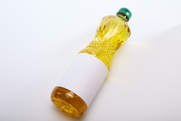 Fototapeta premium Vegetable oil in plastic bottle on white