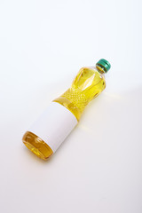 Fototapeta premium Vegetable oil in plastic bottle on white
