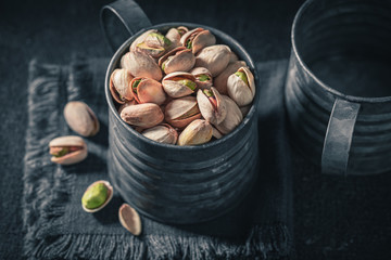 Brown and green pistachios as a ingredient and apetizer