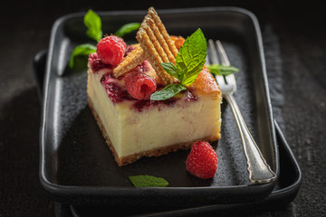 Tasty cheesecake with fresh raspberries and sesame