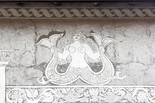 Berguen / Bravuogn, Switzerland &ndash; October 20. 2019: Traditional house facade of a mermaid by Sgraffito technique, which applies layers of plaster tinted in contrasting colours to a moistened surface.