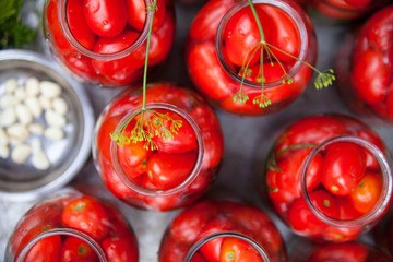 Pickling (canning) the tomatoes.