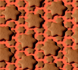 Collection of gingerbread stars on a wooden board with hard shadows on living coral background