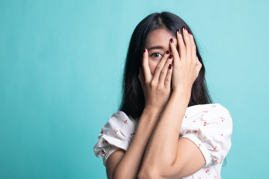 Beautiful Young Asian Woman Peeking Through Fingers