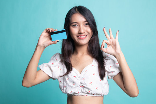 Young Asian woman show OK with a blank card