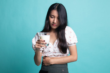 Asian woman drinking a glass of milk got stomachache.