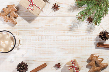 Hot Christmas drink with marshmallows in an iron mug, on a white table. New Year, holiday background, greeting card copy space.