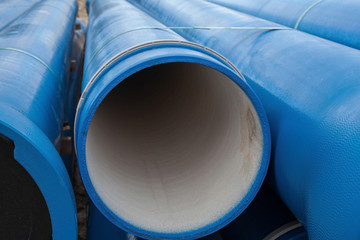 Stack of new blue pipes (tubes)