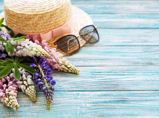 Straw hat and lupine flowers