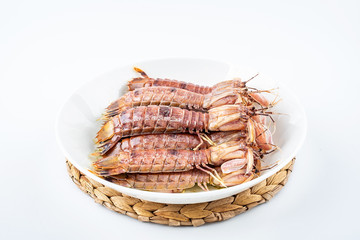 Delicious steamed crusty shrimp on a plate on white background
