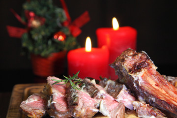 Rib eye steak on the New Year's table. Steak rib eye roast on a wooden board with sauce and salt....