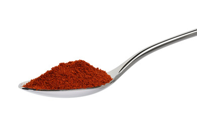 Pile of red paprika powder in spoon isolated on white.Entire image in sharpness.