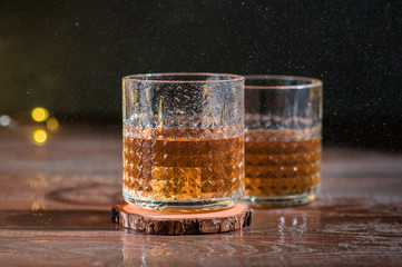 Glass of scotch whiskey on dark background