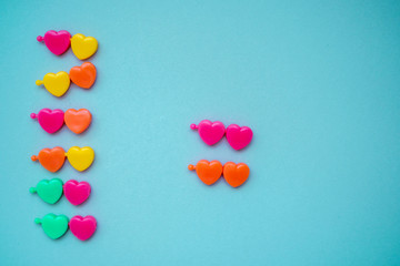 multicolored plastic hearts on a blue background