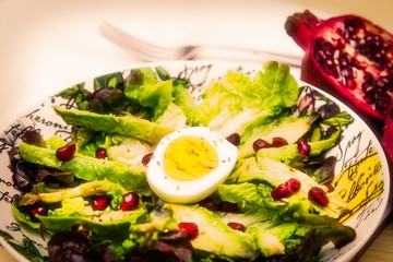 lettuce, avocado and pomegranate salad, diet and health concept