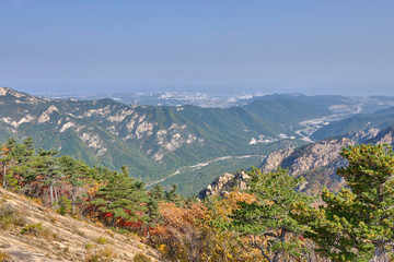 Fototapeta na wymiar Scenic view of mountains of Dinosaur Ridge in Seoraksan national park near Sokcho in South Korea. Beautiful summer sunny look of green rocks in nature reserve on the north of Republic of Korea.