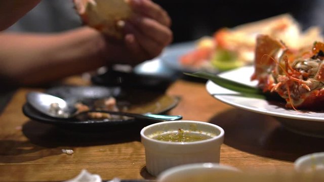 4K Video Unfocused  close up senior couple hands eating dinner together in Japanese restaurant using chopstick for salad and Taraba red king crabs