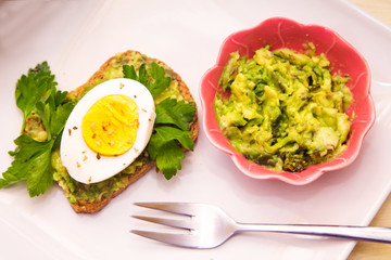 Guacamole toast and hard boiled egg, healthy food