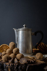 Craft chocolate truffles with metal coffee pot on dark background