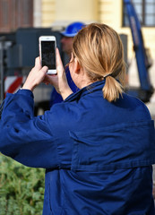 Woman takes photos with her smartphone