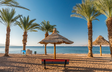 Relaxing facilities on sandy beach in Eilat - famous tourist resort and recreation city in Israel